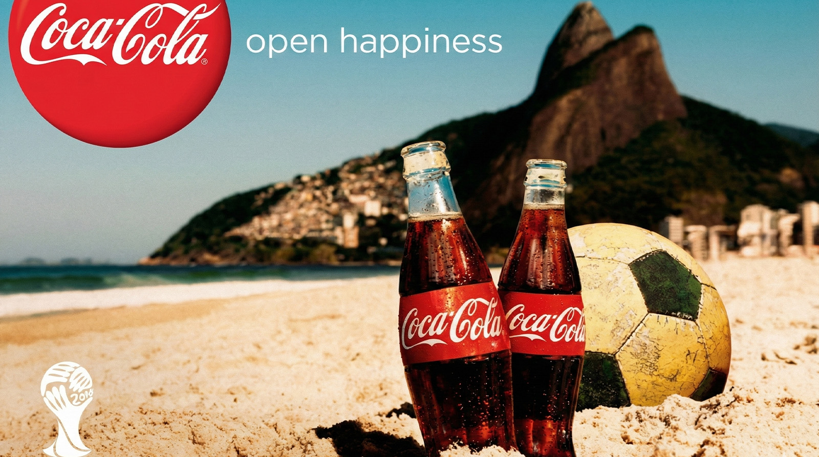 Coca-Cola 'Open Happiness' campaign advertisement featuring bottles on a beach during the FIFA World Cup in Brazil, illustrating the consistency of global brand messaging