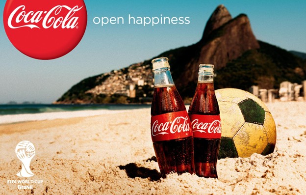 Coca-Cola 'Open Happiness' campaign advertisement featuring bottles on a beach during the FIFA World Cup in Brazil, illustrating the consistency of global brand messaging